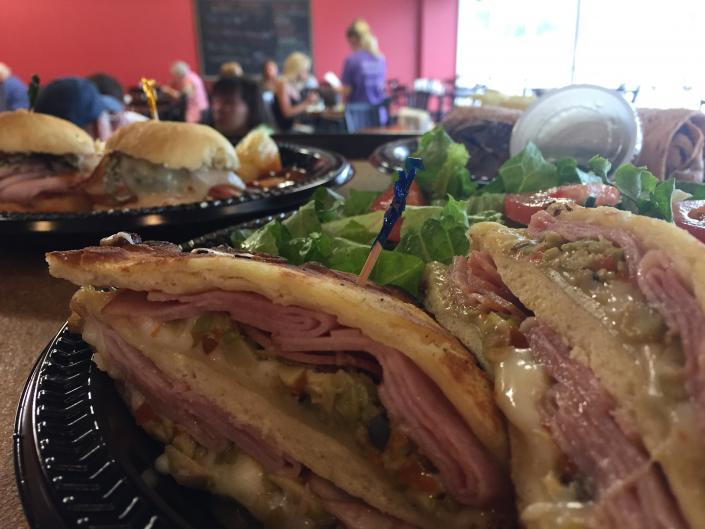 The KTC Mufaletta! Homemade olive salad, fresh ham, and cheese in naan bread and grilled to perfection!
