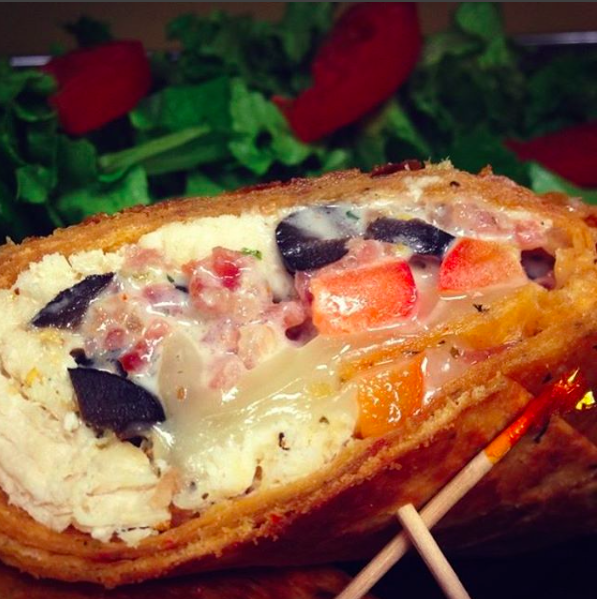 Shredded chicken, red peppers, black olives, and Swiss cheese, grilled.